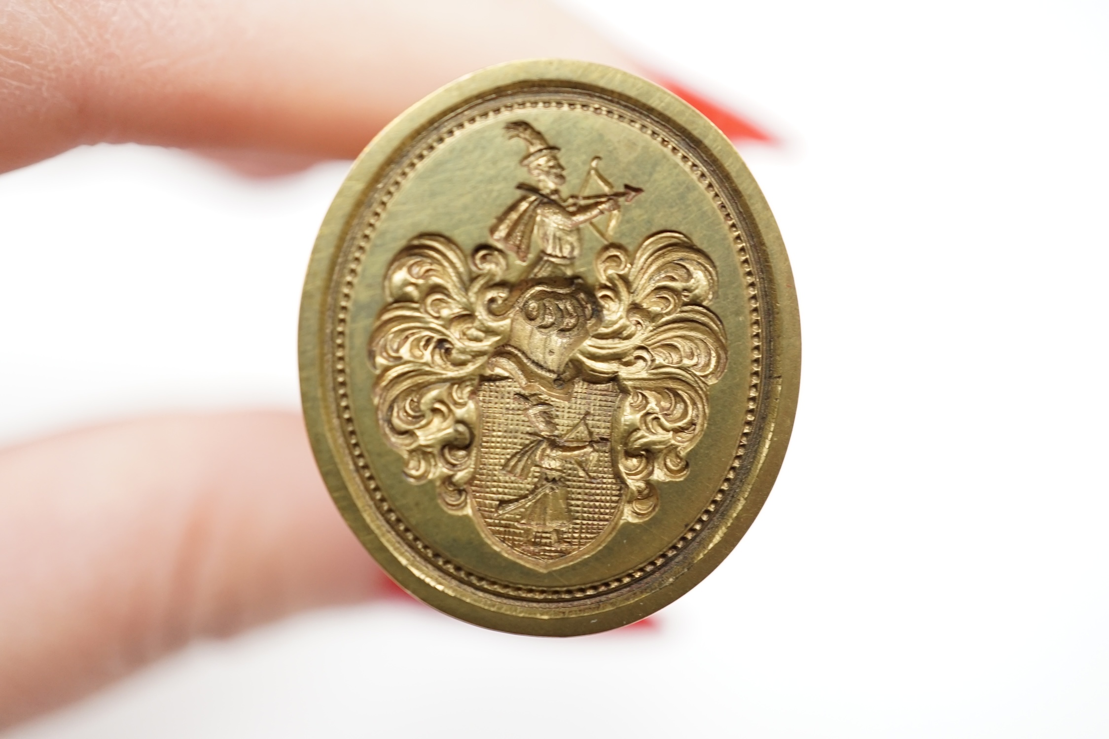 Two 19th century yellow metal overlaid fob seals, one with carnelian stone carved with a crest, 28mm, a base metal table seal and a pinchbeck seal.